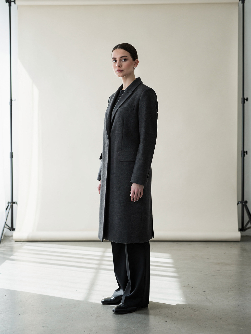 Model in tailored wool outerwear posing in natural daylight