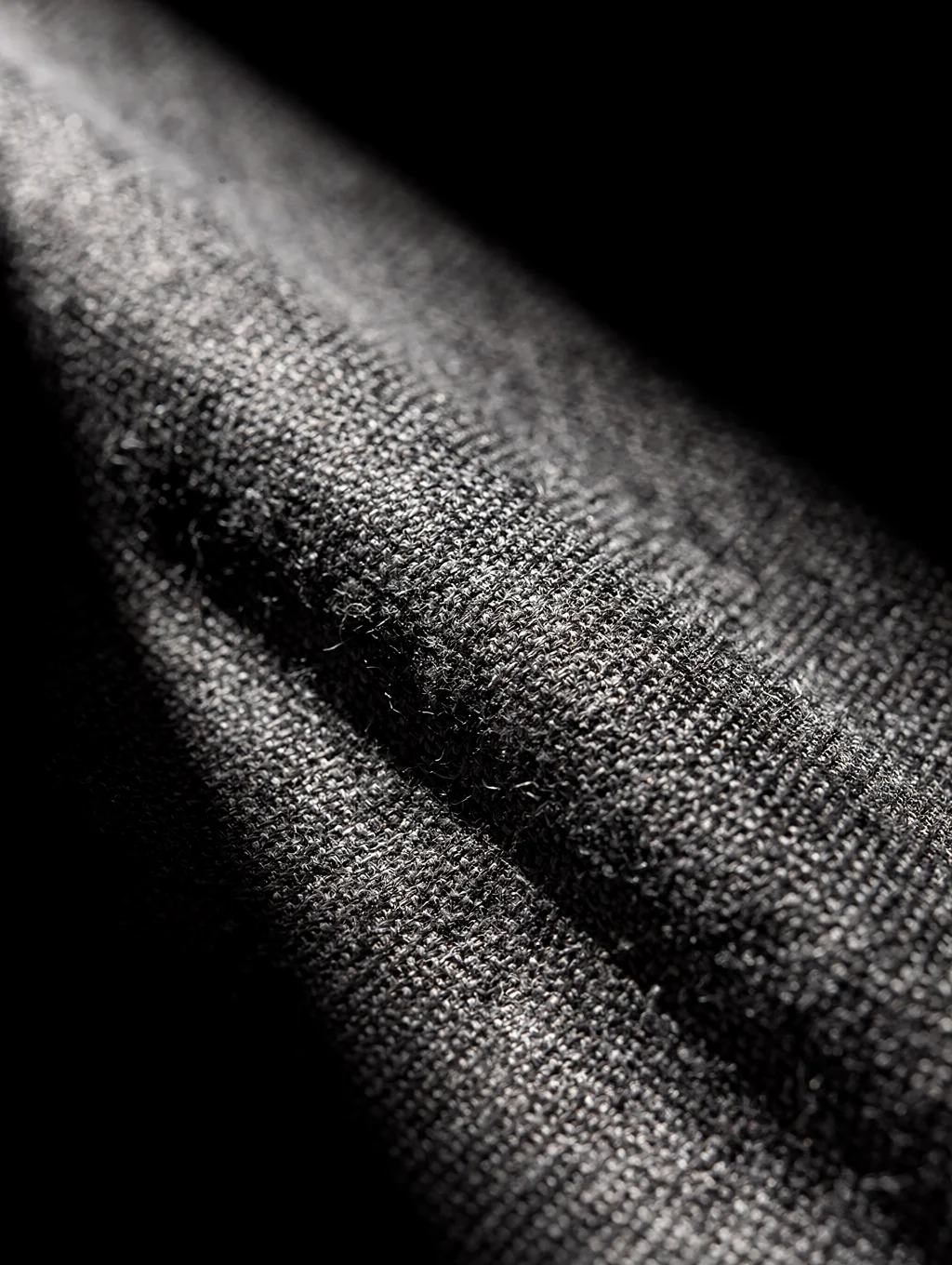 Close-up detail of natural fabric textures and tailor stitching in warm daylight